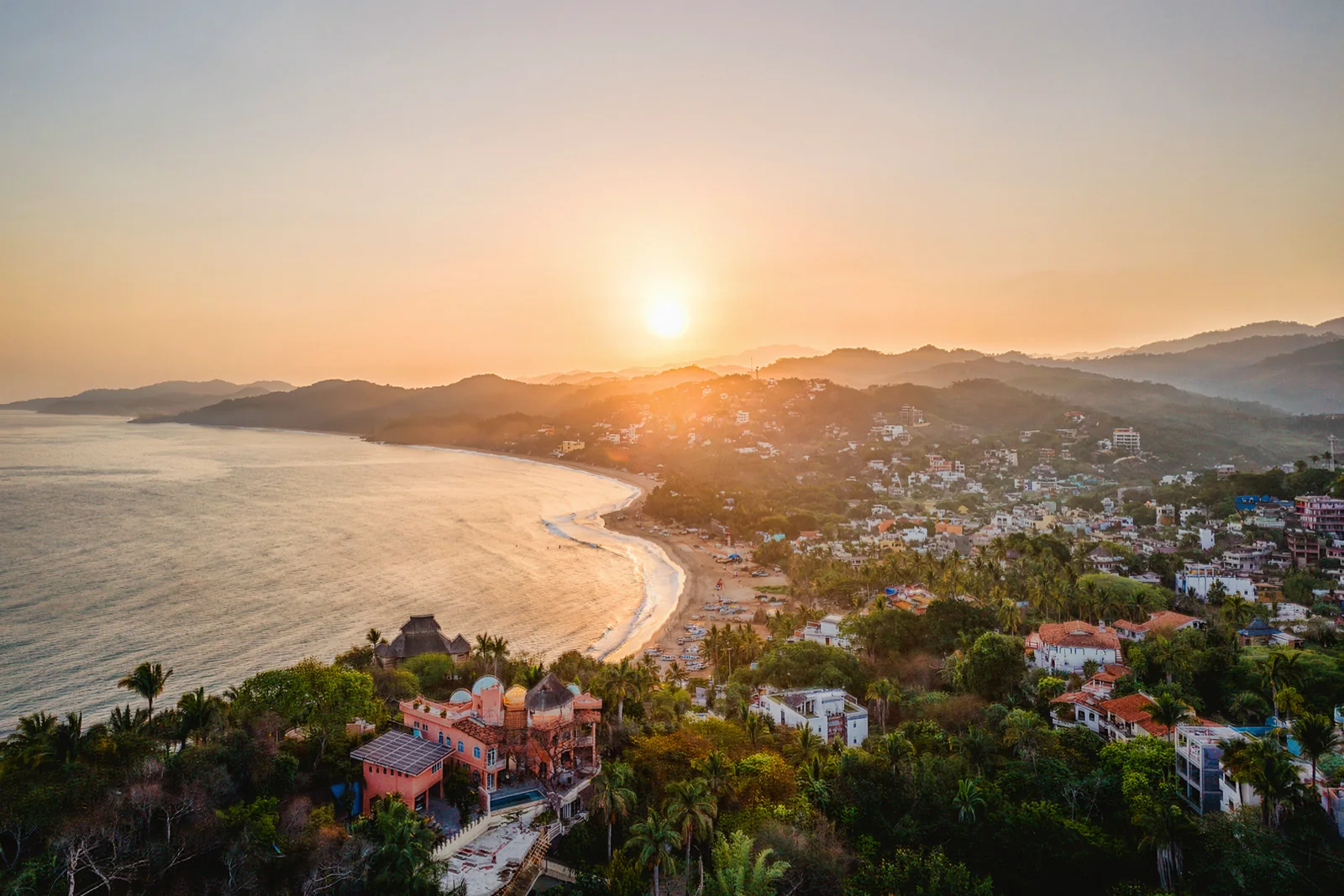 The sun setting over Sayulita’s bay and hillside